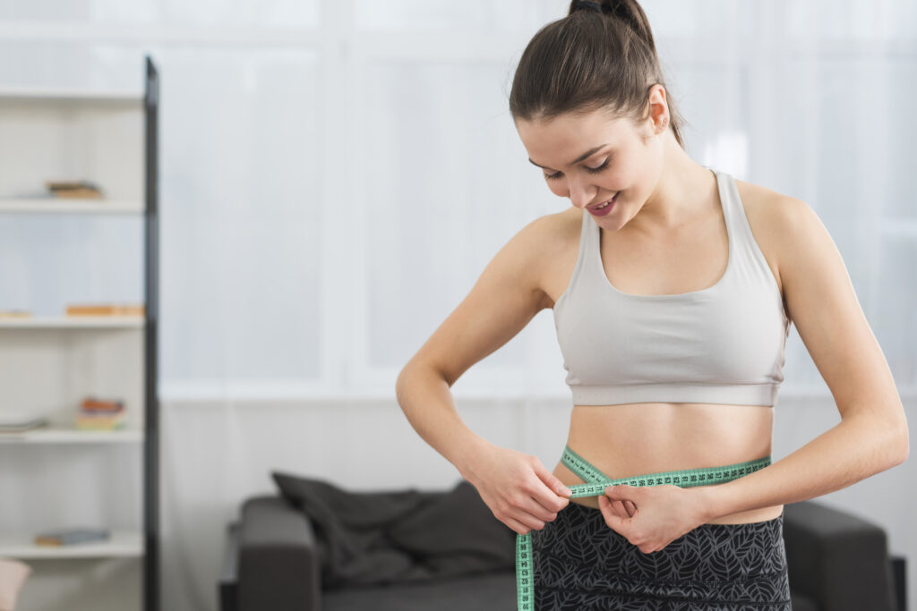 10 Benefits of Drinking Hot Water in the Morning for Better Health 5 fitness girl measuring herself